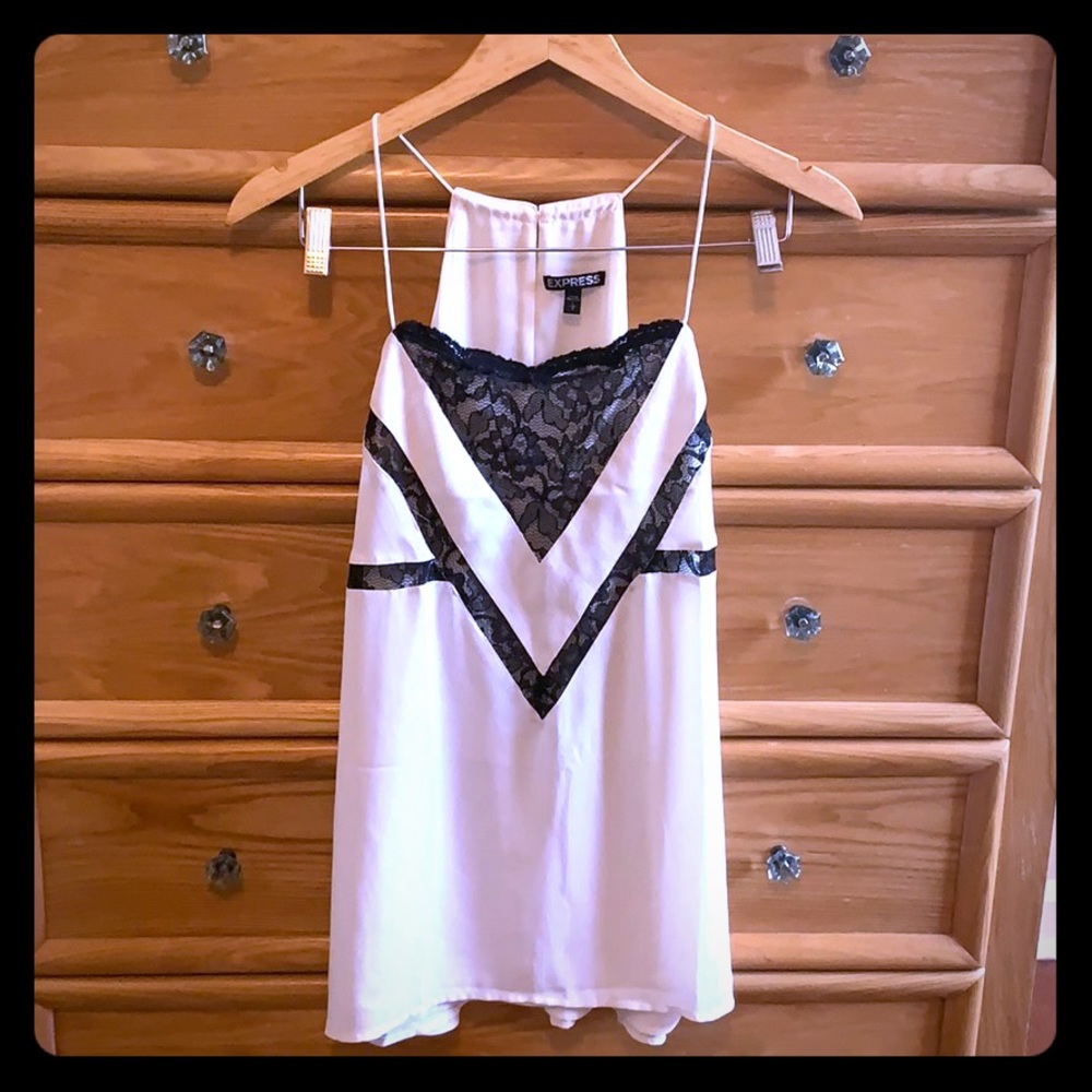 Cream colored blouse with black lace detail.